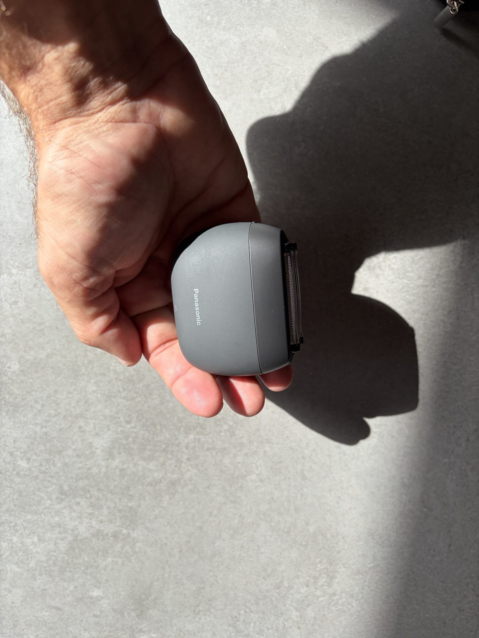 Side profile of the Panasonic ES-PV3B held between fingers