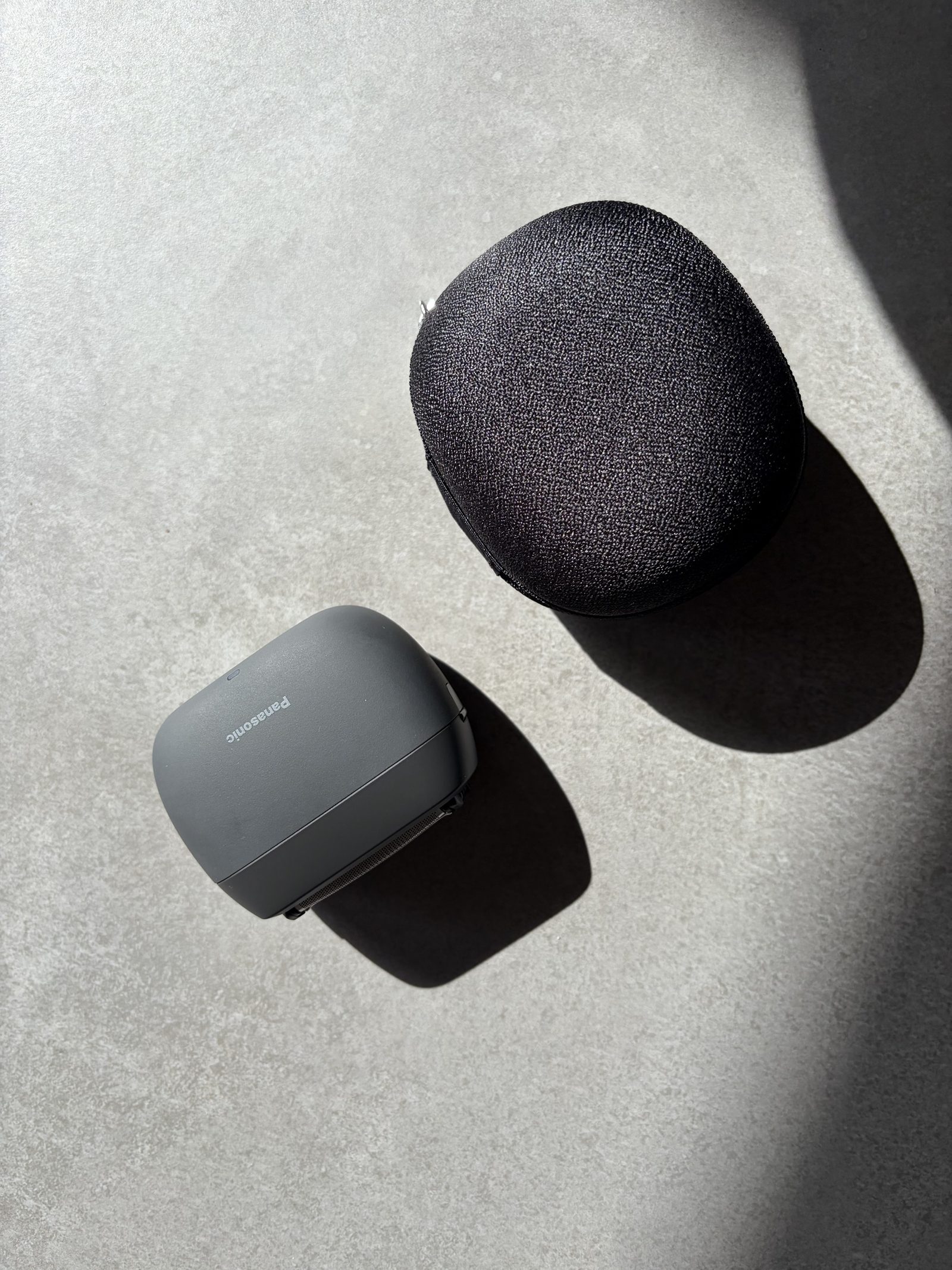 Panasonic ES-PV3B shaver next to its case on concrete