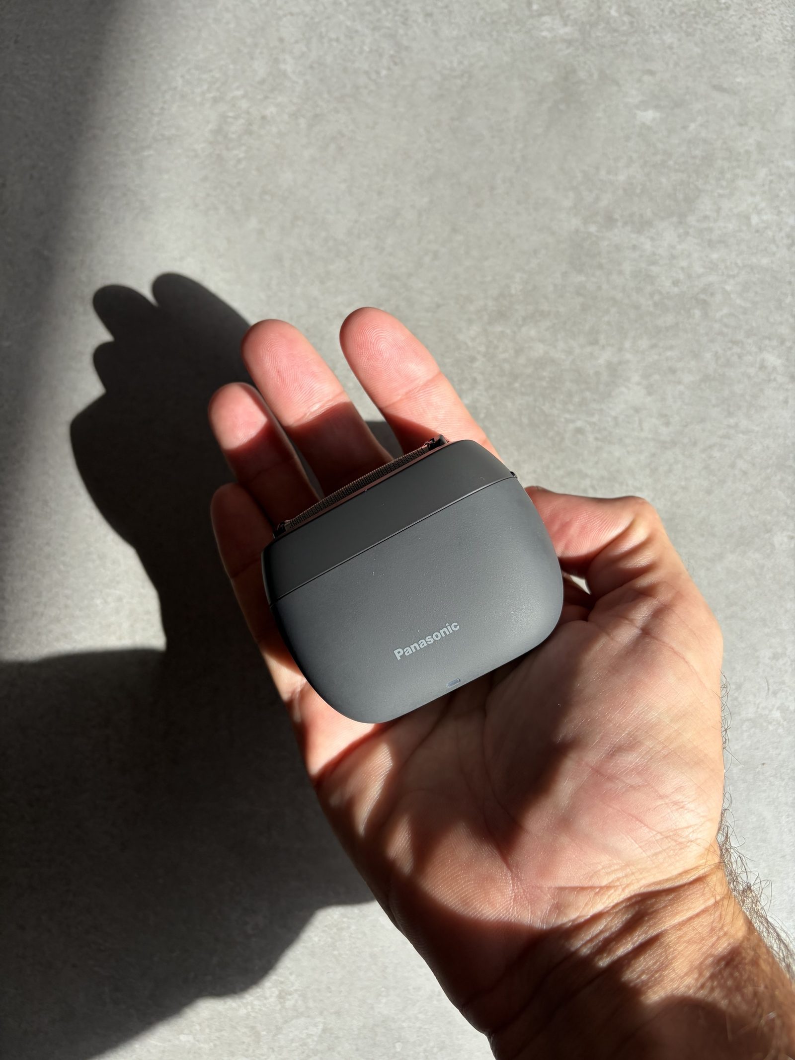 Panasonic ES-PV3B sitting in an open palm to show its size