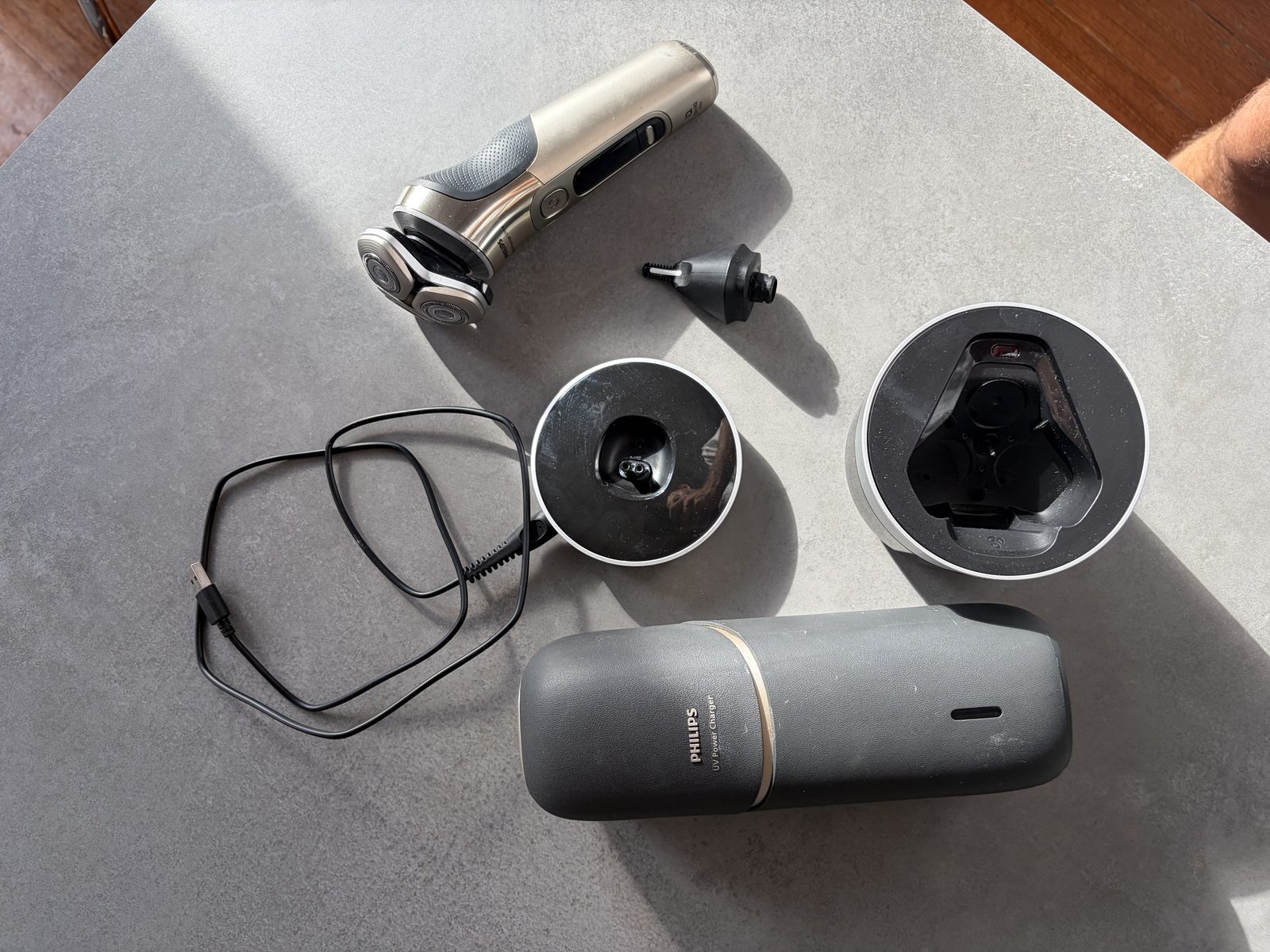 The Philips with its UV charging case, charging pod, cleaning pod and trimmer attachment