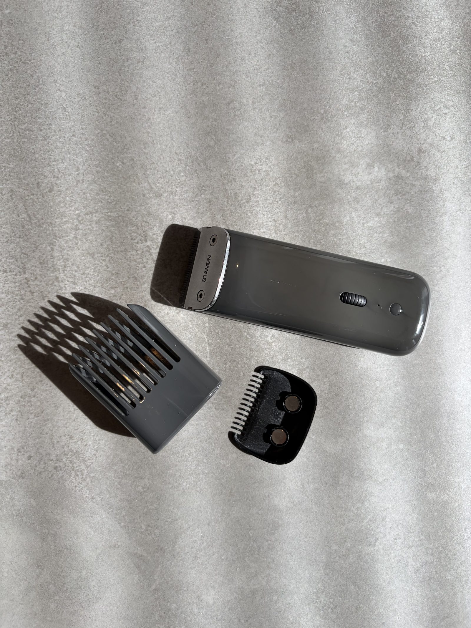 The Stamen ST-01 trimmer with its adjustable comb and magnetic 1.5mm tight guard, in striped window light